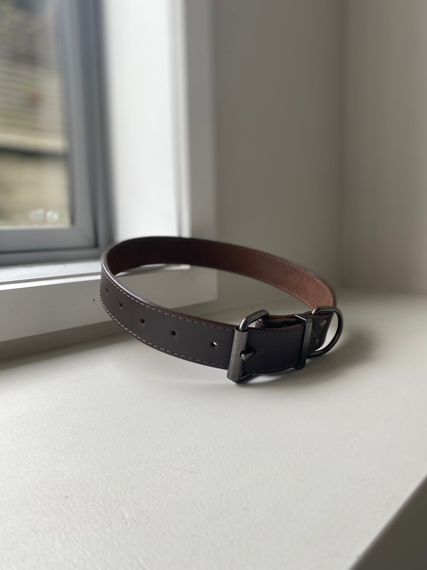 Brown leather dog collar on a white background