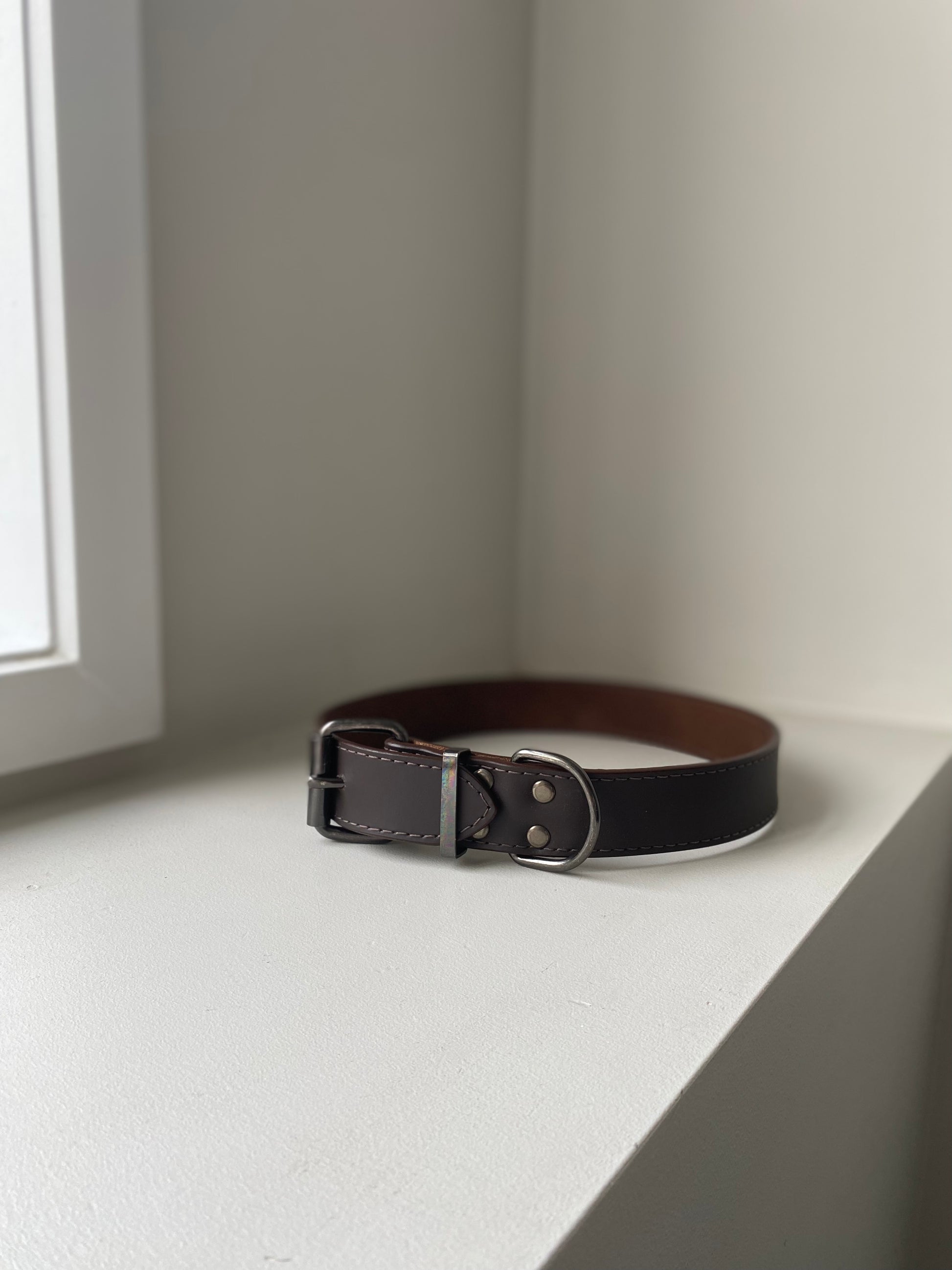brown leather dog collar on a white background