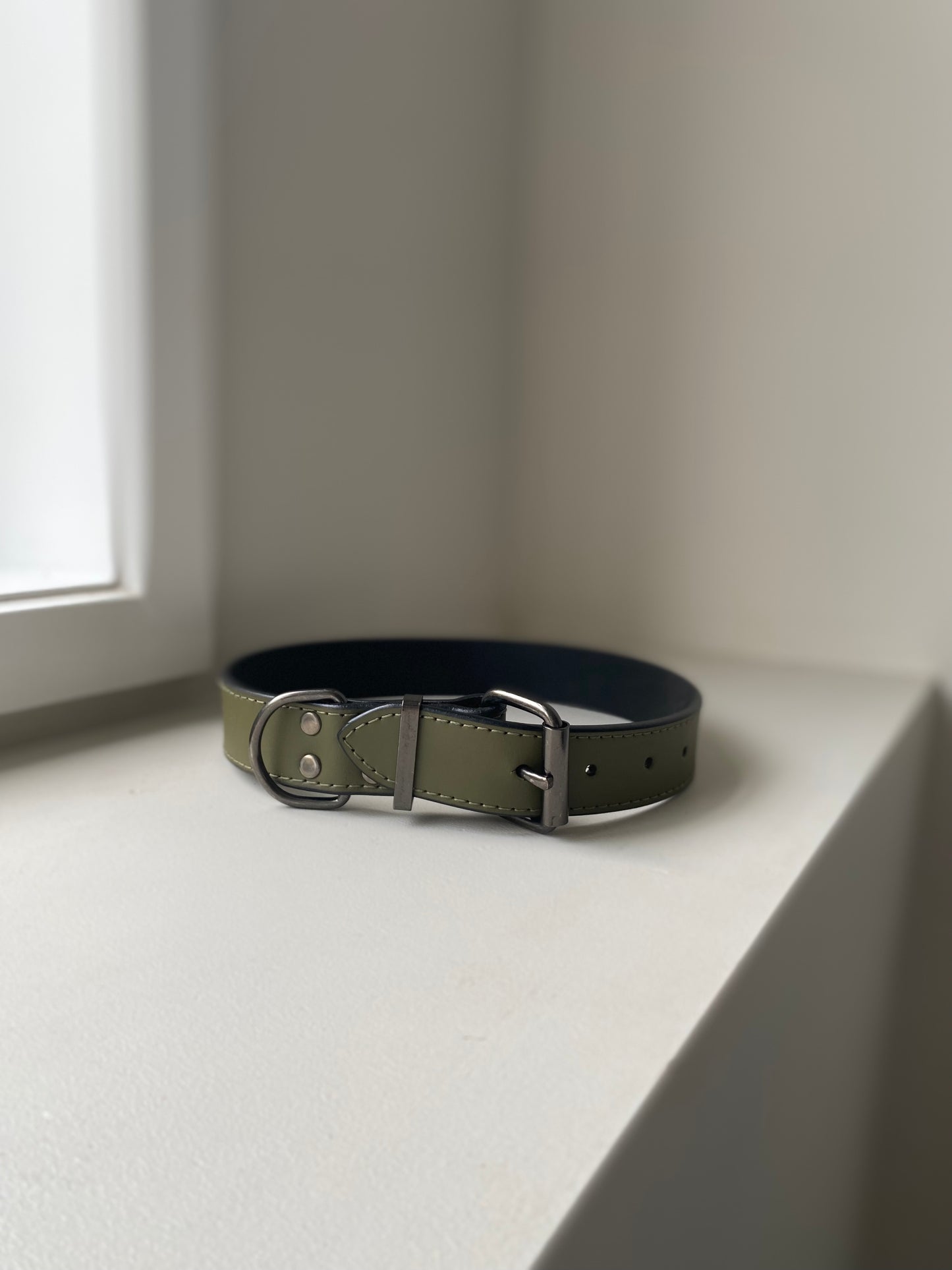 khaki green leather collar on a white background 
